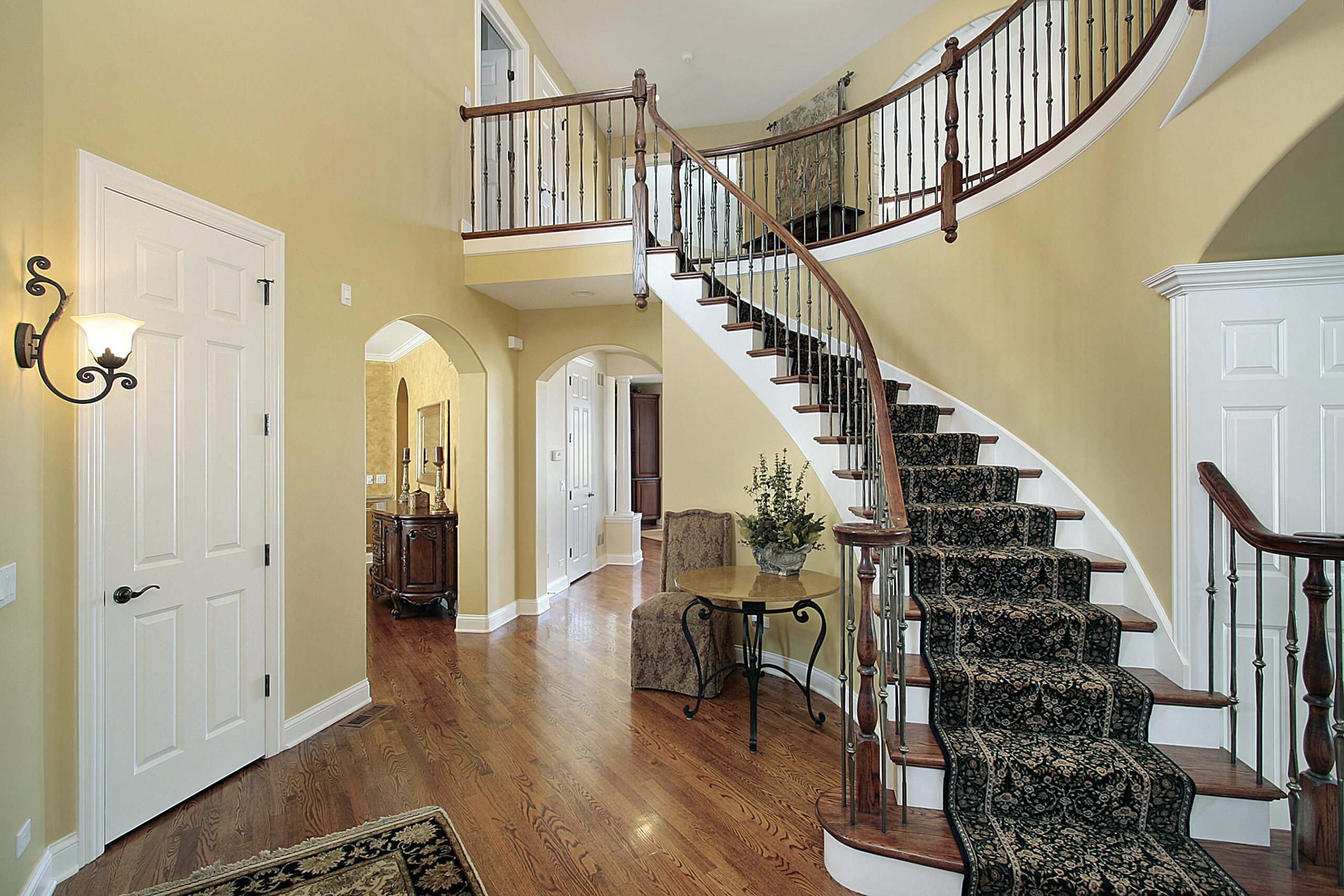 Foyer in luxury home with curved staircase