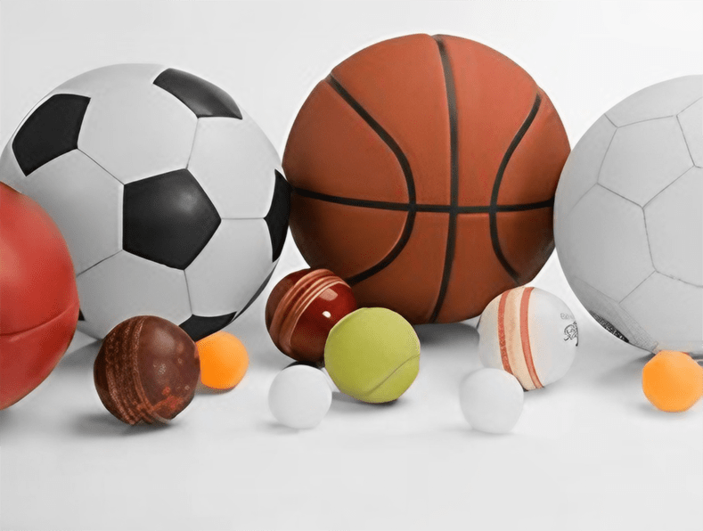 A row of various balls, including soccer, basketball, and tennis balls, neatly arranged side by side