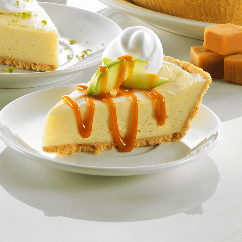 A slice of pie on a plate, drizzled with rich caramel sauce, inviting and deliciously presented.